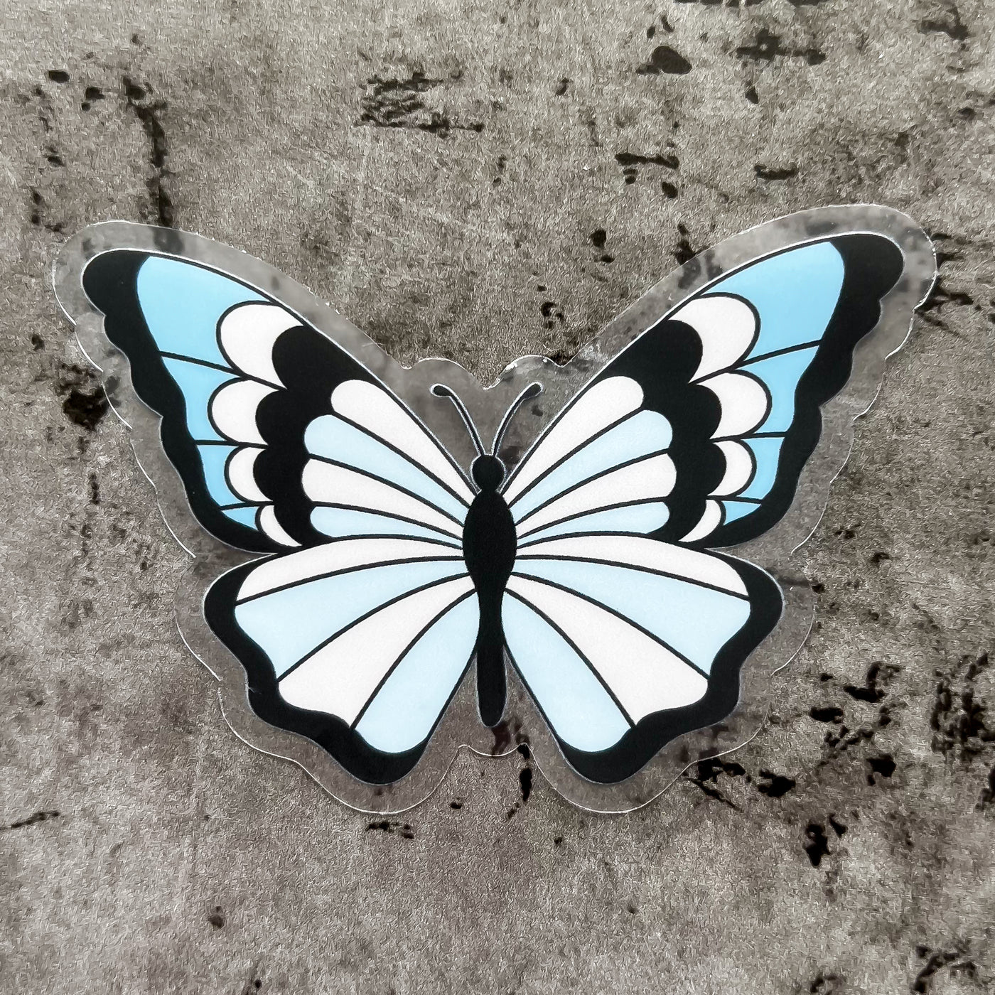 Clear pink and blue butterfly vinyl sticker by Simpliday Paper by Olga Nagorna comes with a solid white backing, but is clear once the backing is removed.