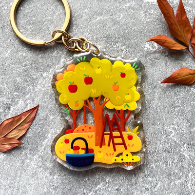 Autumn apple picking transparent acrylic keychain. Double-sided, backside is the same design, but reversed.